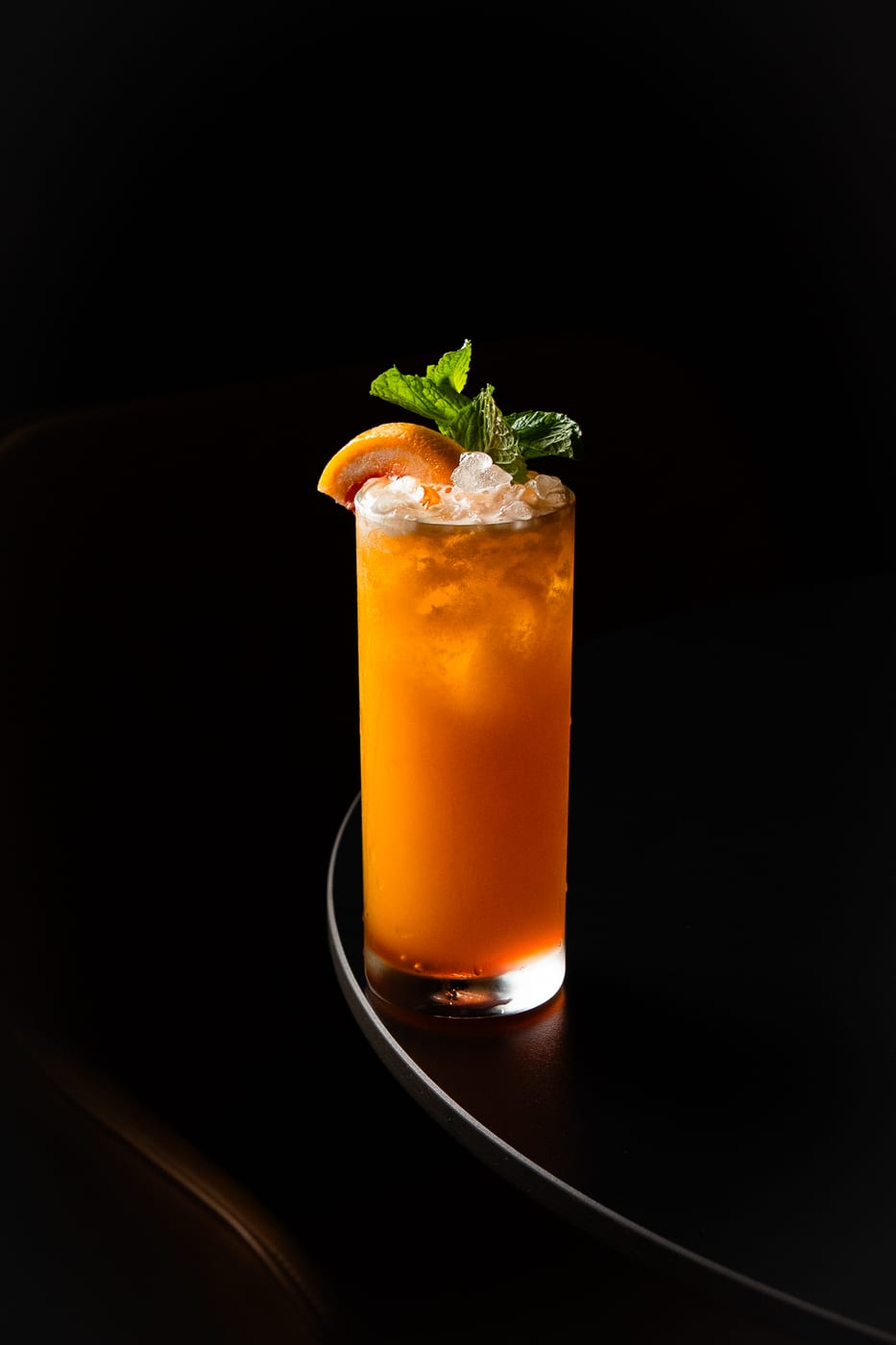 Caribeno signature cocktail at OCCO Business Bay Dubai — orange passion fruit and grapefruit cocktail with mint