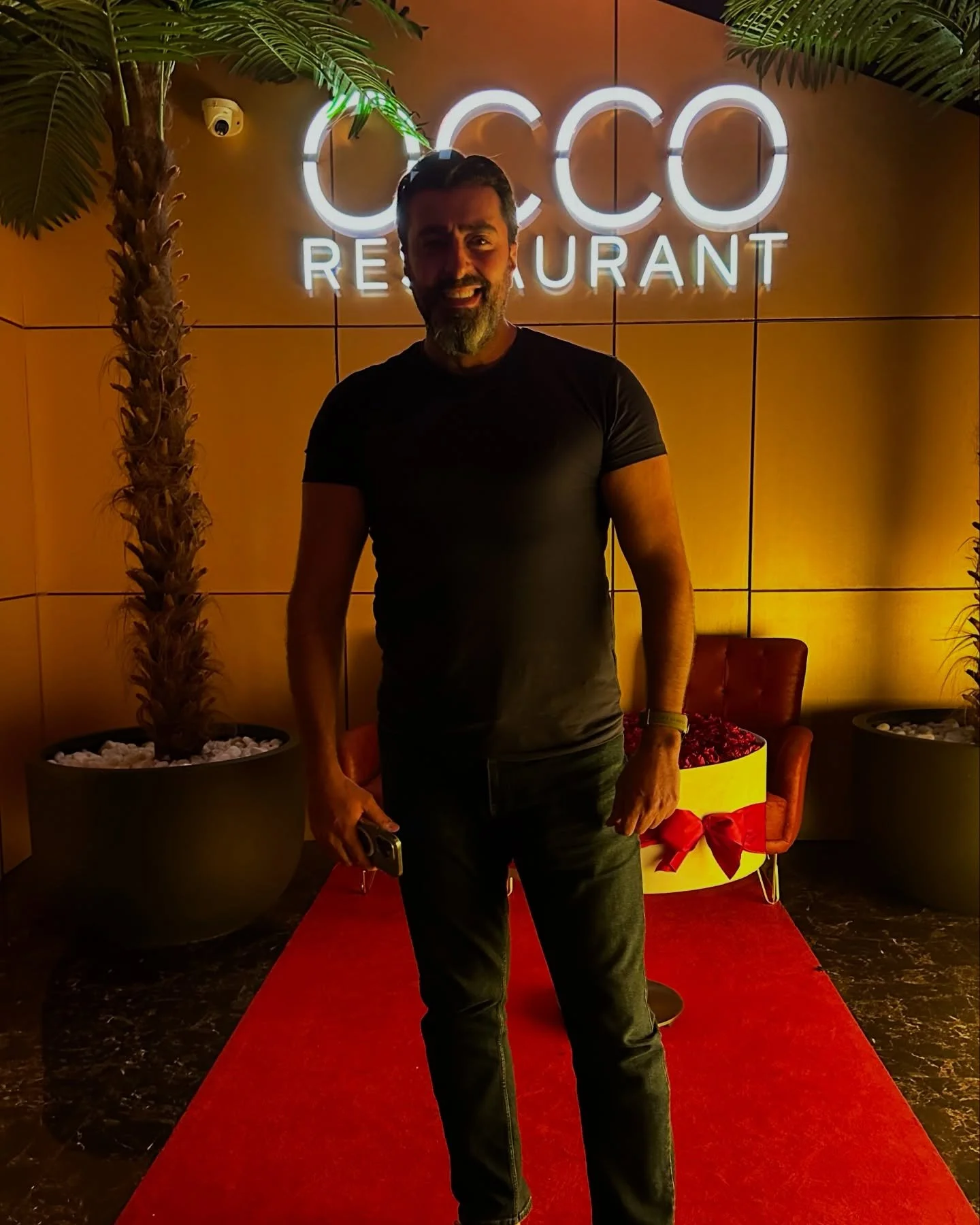 The OCCO Business Bay entrance at Hyde Dubai at night, lit signage above a red carpet
