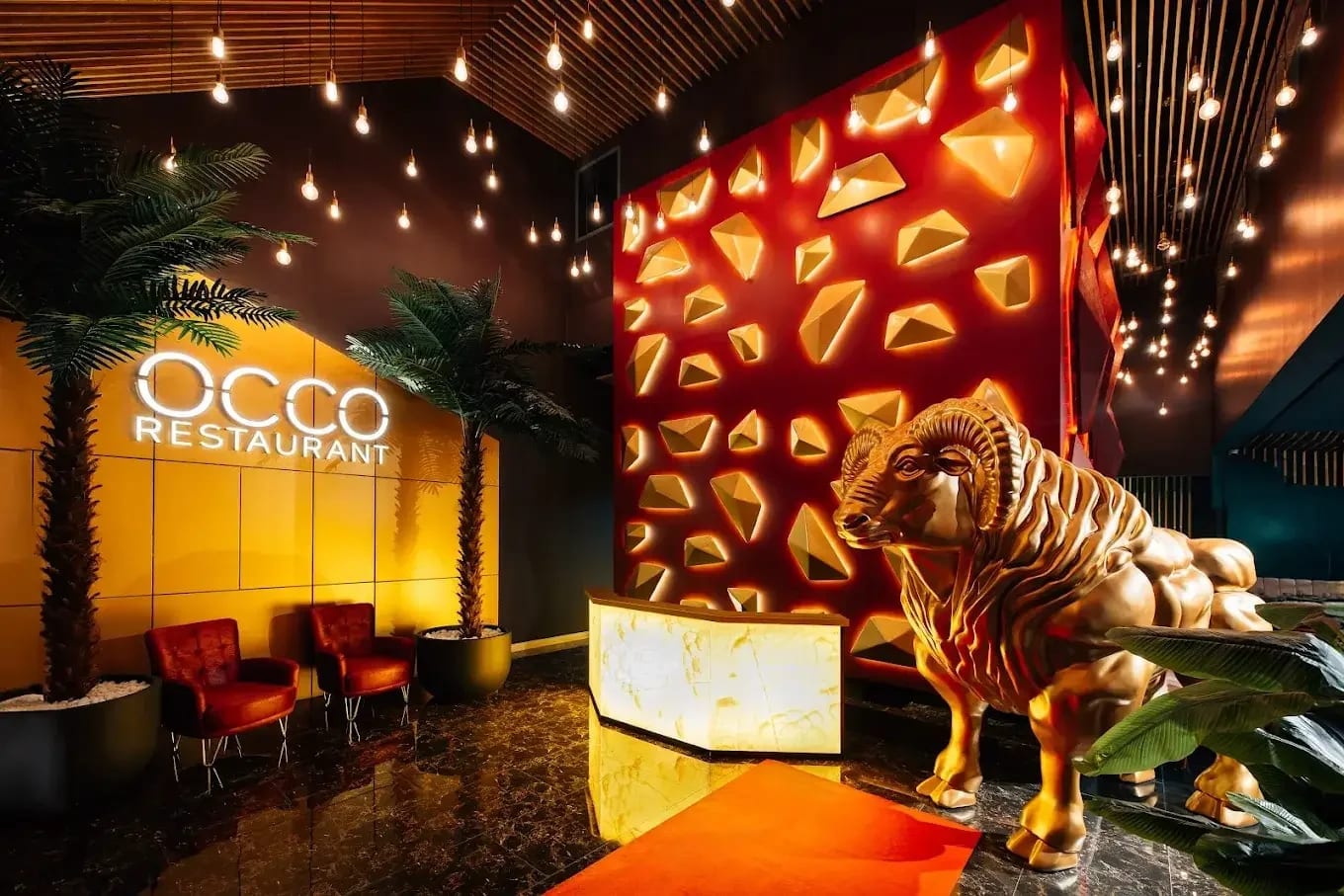 The OCCO Hessa entrance lobby with its golden ram sculpture and red faceted wall