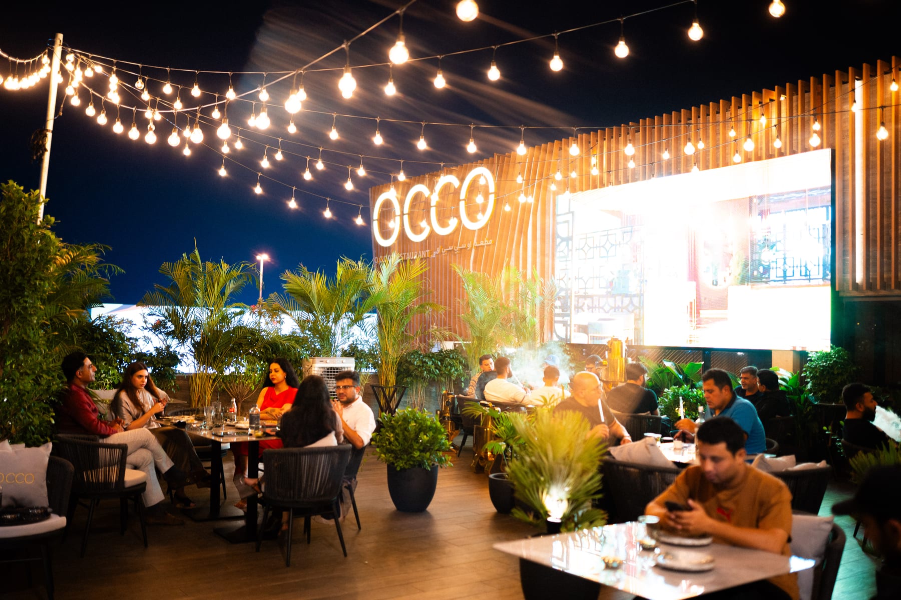 The OCCO Hessa terrace at night under string lights