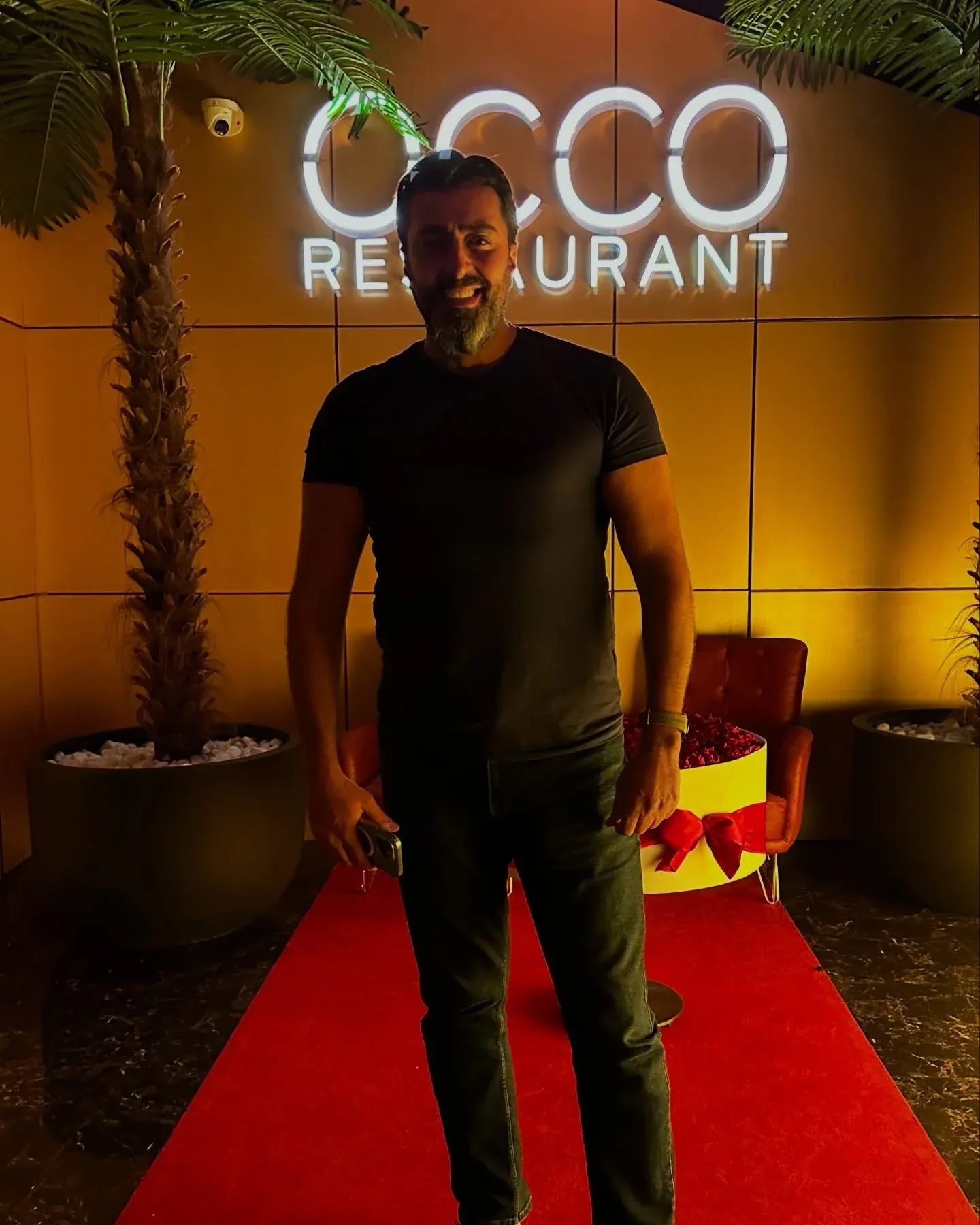The OCCO Business Bay entrance at Hyde Dubai at night, lit signage above a red carpet