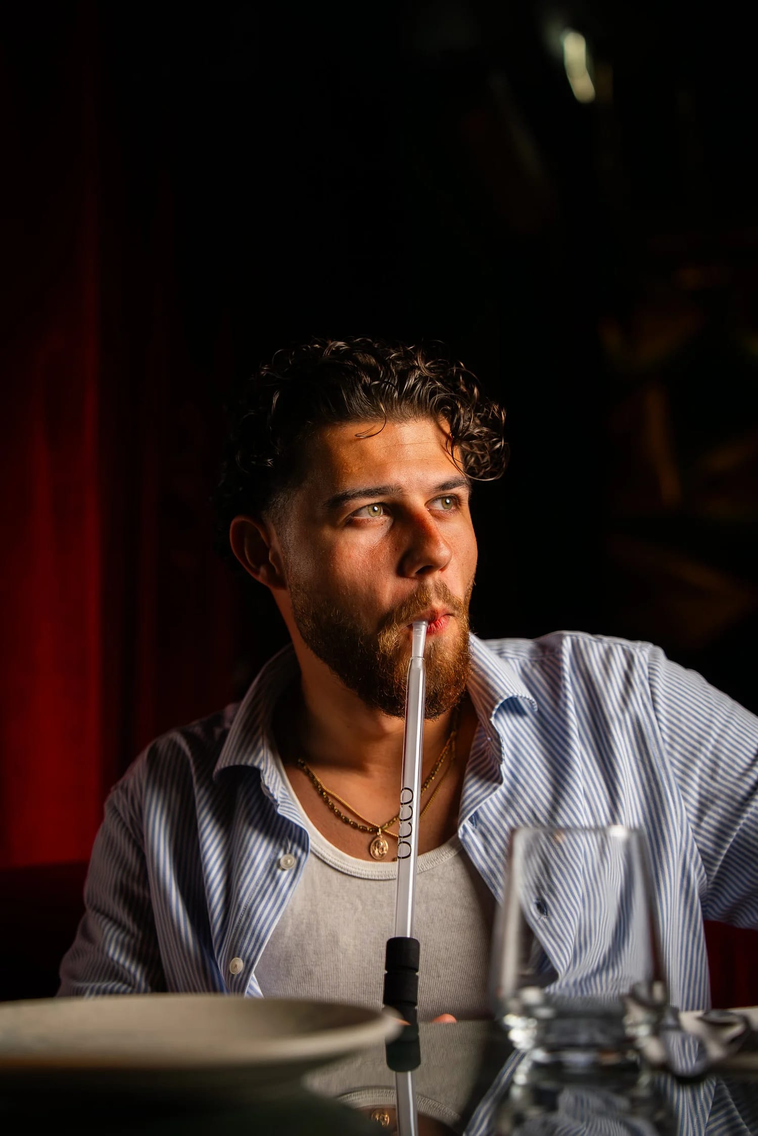 A guest enjoying shisha in the low light at OCCO